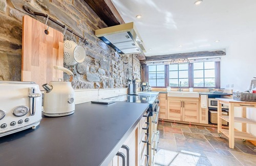 Ferryside Cottage | Picked for its luxury finish inside, stunning estuary views and a private hot tub.