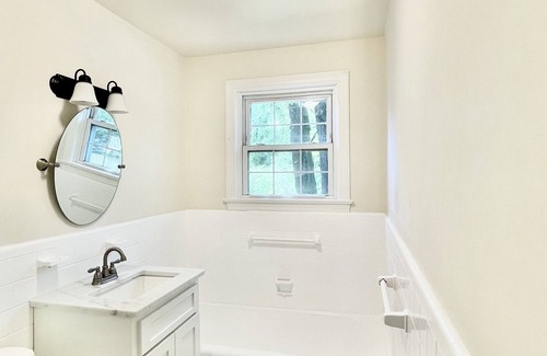 Midtown Cottage | Quaint cottage style home with two sitting areas-2 minutes to shops and eateries