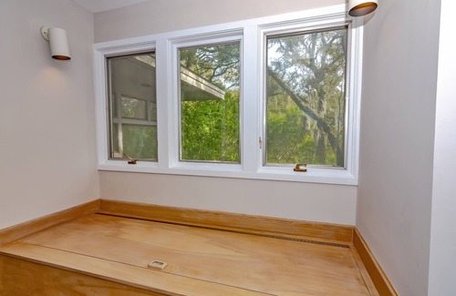 Bald Head Island House | Resting in treetop, two golf carts close to island amenities