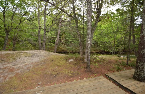 Glen Arbor Condo | Riverfront condo with water views, deck, fireplace, W/D, and community firepit