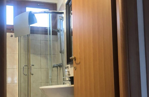 Raveo House | Rustic apartment with beams and stone.