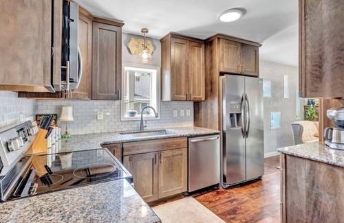 Central Colorado Springs House | Sink into the Hot Tub and start relaxing at the beautiful, bright Cedar House