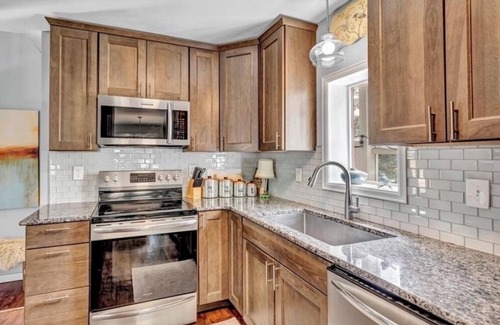 Central Colorado Springs House | Sink into the Hot Tub and start relaxing at the beautiful, bright Cedar House