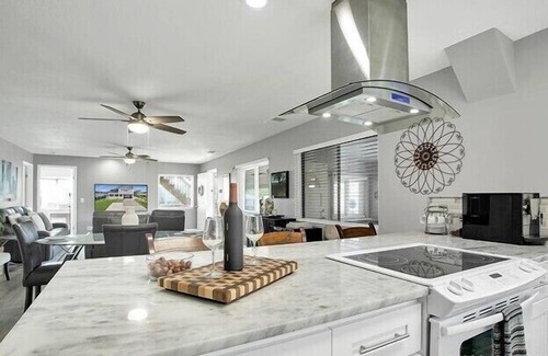 New Smyrna Beach House | Spacious 3BR, 2BA beach home just a short walk from the sand! Three bedrooms up, private queen room and bath down. Secure 2-car garage for vehicles or a small boat. Perfect for families or groups. 30-day minimum stay required.