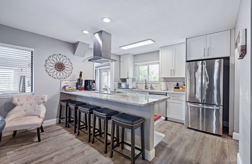 New Smyrna Beach House | Spacious 3BR, 2BA beach home just a short walk from the sand! Three bedrooms up, private queen room and bath down. Secure 2-car garage for vehicles or a small boat. Perfect for families or groups. 30-day minimum stay required.