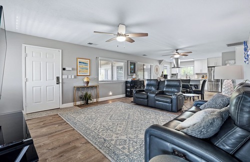 New Smyrna Beach House | Spacious 3BR, 2BA beach home just a short walk from the sand! Three bedrooms up, private queen room and bath down. Secure 2-car garage for vehicles or a small boat. Perfect for families or groups. 30-day minimum stay required.