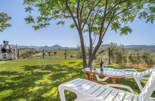 Prado del Rey House | Spend the vacation in this inviting cottage with magnificent mountain panorama.