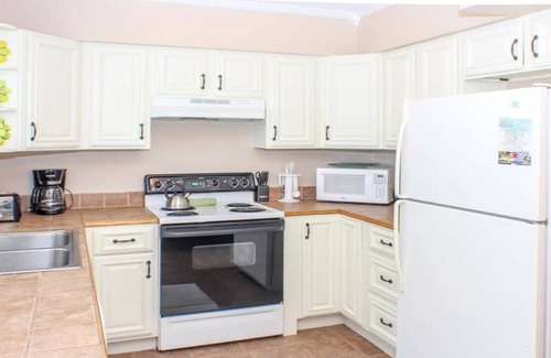 Holmes Beach Villa | Steps to the Beach with Shared Heated Salt Pool and Private Backyard & Grill