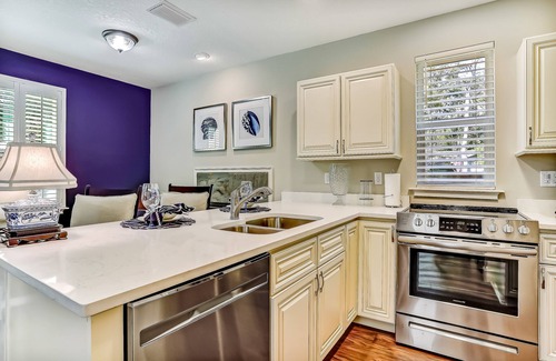 American Beach Condo | Stylish & sun-filled retreat with large patio & fireplace - near beaches & golf