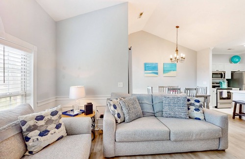 Little River Condo | Sunny condo with pool access, coastal theme, balcony, W/D, and central AC