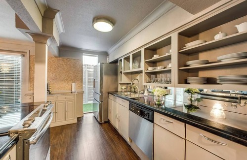 Lower Greenville Condo | Tailored for comfort and productivity, this two-bedroom executive condo features a full kitchen with premium appliances, an elegant dining room, and spacious living areas. Both bedrooms include plush king beds, full-size closets, and stylish dressers