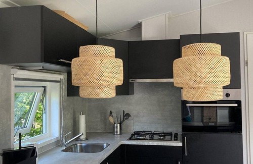 Sint Maartensvlotbrug House | Tastefully furnished, cosy and modern 4-person chalet with 2 bedrooms. Lovely garden with terrace, veranda and lawn. Free WiFi.
