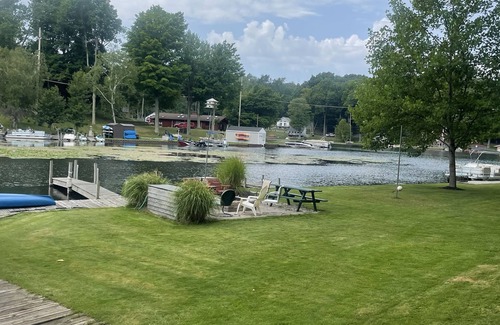 Ludington Cottage | The Bay Cottage has wonderful views of Hamlin lake from its deck 50’ from lake