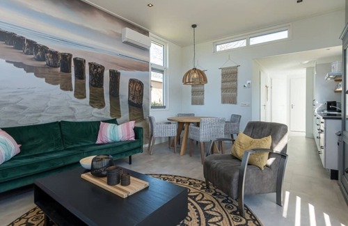 Burgh-Haamstede House | This chalet is beautifully finished both inside and outside. The landscaping, canopy, poster walls a