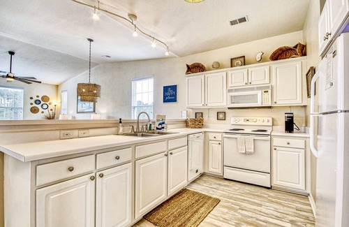 Sunset Beach Condo | Top-floor, end-unit condo with water/golf course views, pools, tennis, & grills