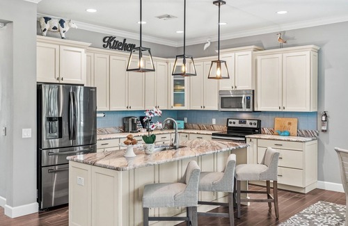 Cocoa Beach House | Tropical Backyard Oasis w/ Screened in Outdoor Patio, Pool, Gas Firepit & BBQ Grill!