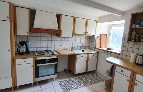 Ushant House | Typical Ouessantine house entirely renovated with its enclosed garden planted with trees.