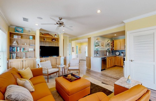 Hatteras Condo | Vibrant beach retreat with washer/dryer, central AC, deck, & pool access