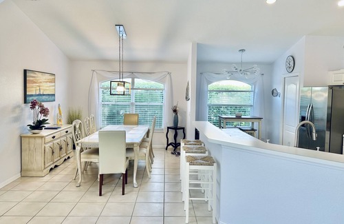 Central Naples House | Villa in gated community -Large South facing saltwater heated pool- lake views!