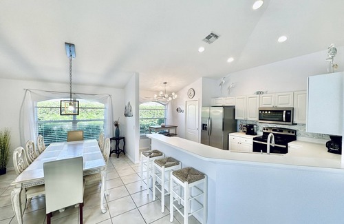 Central Naples House | Villa in gated community -Large South facing saltwater heated pool- lake views!