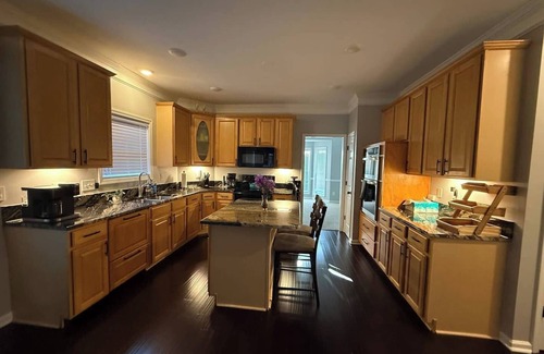 Greensboro House | Welcome to The Clovelly, a spacious 2-story vacation home that blends charm with modern comfort. Perfect for families, friends, or groups, this cozy retreat features inviting living spaces, a fully equipped modern kitchen & comfortable bedrooms.