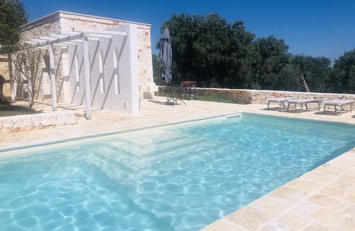 Ostuni Villa | White stone typical apulian villa with barrel roof surrounded by olive trees.