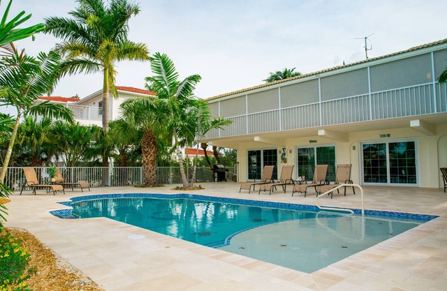 4 bedroom/3 bathroom on Canal w/HEATED POOL and New Outdoor kitchen w/Bar Area