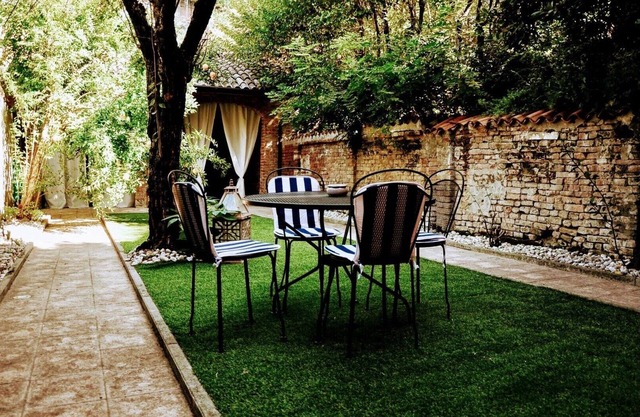 A garden in the shadow of the Torrazzo