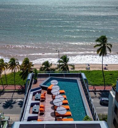 Acorde com o som do mar no Cabo Branco - flat com piscina aquecida e ar condicionado