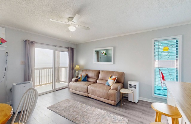 Beachfront condo with ocean views, balcony, WiFi, & shared grills