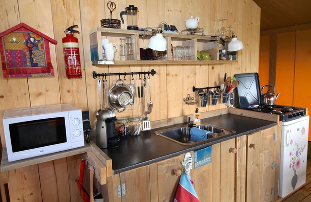 Beautiful furnished safari tent and circus wagon with private bathroom.