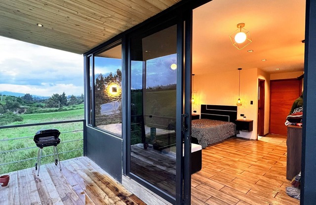 Cabin by the river with a view of the Cayambe snow-capped mountain