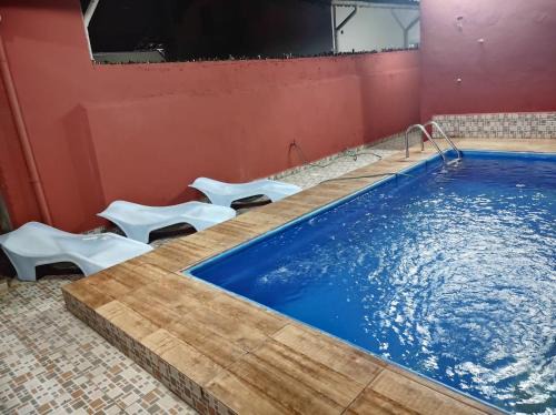 Casa na Praia Grande com Churrasqueira e Piscina.