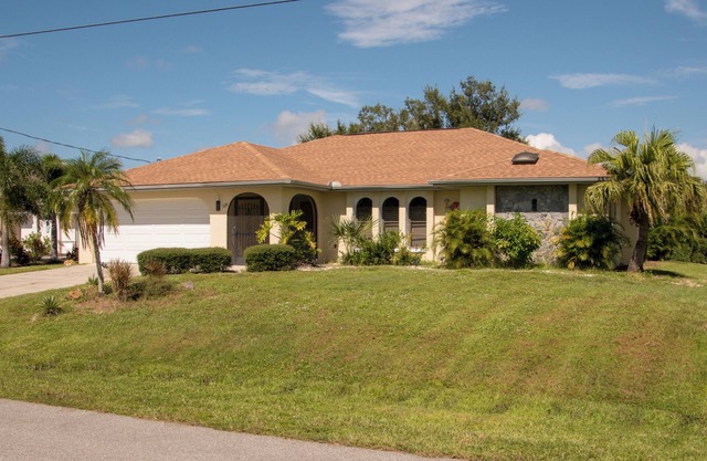 Charming 3-bedroom house in Port Charlotte on canal with dock and private pool.