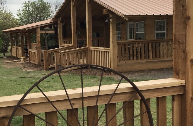 Cottage is tucked away among trees and a small vineyard.