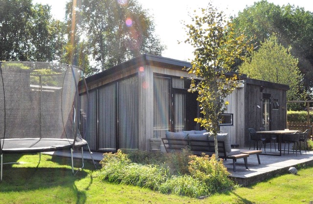 Detached chalet in Friesland with fenced garden and unobstructed view.