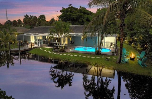 Enjoy a stunning waterfront view, pool table,kayaks, fishing, BBQ, heated & pool