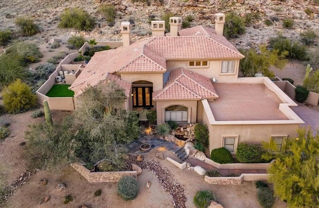 Enjoy breathtaking views of the mountainside throughout this hillside estate.