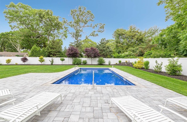 Expanded ranch in Hampton Bays with beautiful backyard w heated pool, sleeps 12n