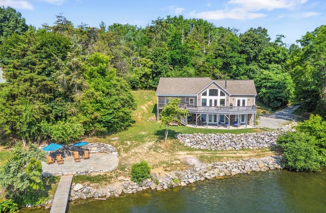 Experience the perfect blend of rustic charm and modern luxury in this Claytor lakefront retreat