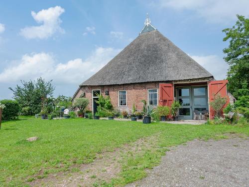 Farmhouse by Lauwers River with Rowing Boat