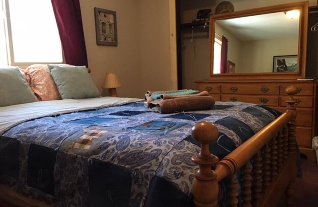 Furnished bedroom in our Home with full size bed, shared bath