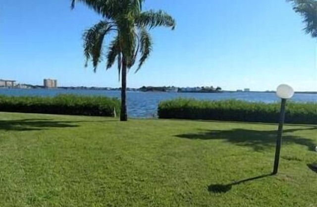 Incredible ground floor villa with water views of Bay and waterside pool!