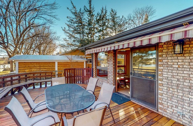 Lake-view home with gas fireplaces, inviting deck & dog-friendly yard