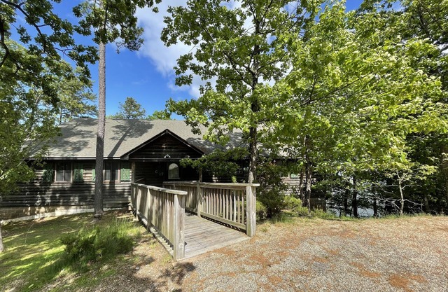Lake view three bedroom, three bath log-sided cottage with private hot tub overlooking Lake Ouachita. by RedAwning
