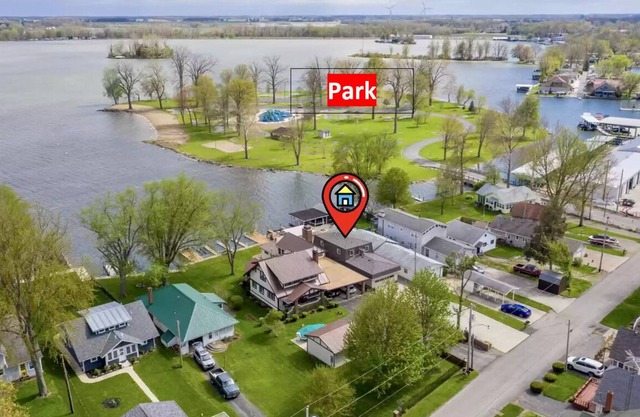 Lakefront, covered patio, open water views with boat dock.