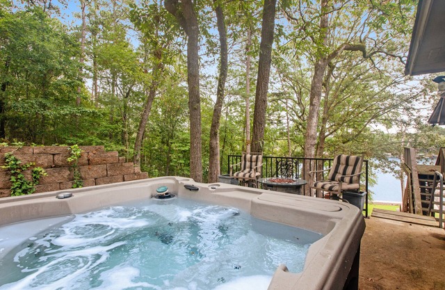 Lakefront dog-friendly home with lake views, dock, firepit, & grill area by lake