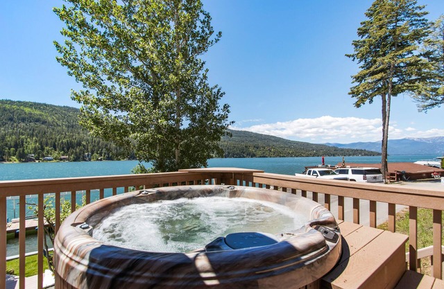 Lakefront home with tiki bar, private dock, hot tub, decks, fire pit, & kayaks