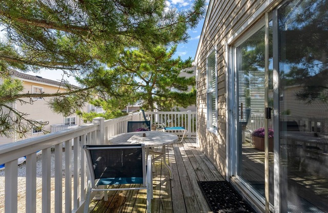 Light filled carriage house with gorgeous wrap around deck, ready for a perfect vacation getaway.