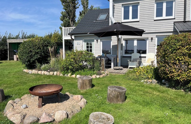 Lovingly furnished beach house, directly on the beach with fireplace and large garden